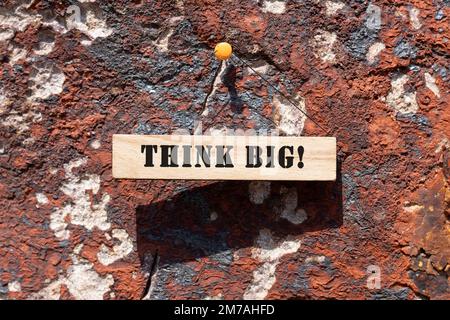 Think big is written on the wooden surface. Wooden Concept. Stock Photo