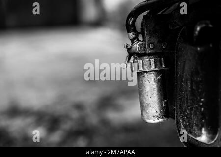 Diesel fuel filter on the body of a walk-behind tractor close-up, black and white photo Stock Photo