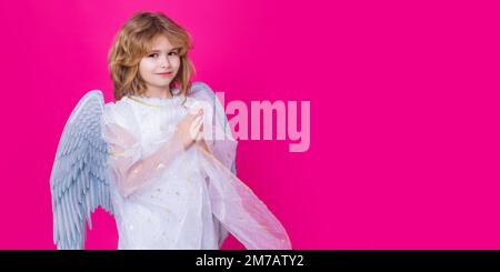 Valentines day banner. Cute child with angel wings with prayer hands, hope and pray concept. Banner header with copy space. Stock Photo