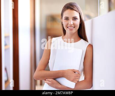 Home living made easy. a young woman holding a tablet pc. Stock Photo