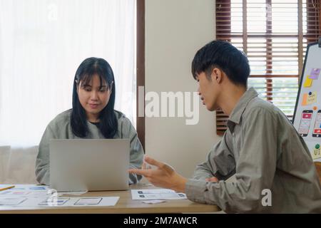 Young Asian Start up new business working at creative office. Modern start-up business team. Co-workers ui, ux startup small business Stock Photo