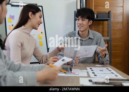 Young Asian Start up new business working at creative office. Modern start-up business team. Co-workers ui, ux startup small business Stock Photo