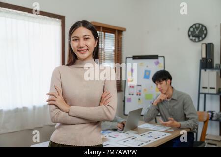 Young Asian Start up new business working at creative office. Modern start-up business team. Co-workers ui, ux startup small business Stock Photo