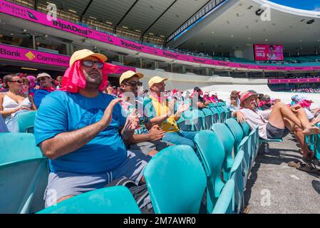 Jan 2023: Three young Australians wearing pink and watching play at the 3rd Cricket (Pink) Test Match between Australia and South Africa Stock Photo