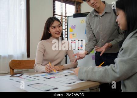 Young Asian Start up new business working at creative office. Modern start-up business team. Co-workers ui, ux startup small business Stock Photo