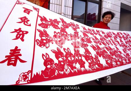 HANDAN, CHINA - JANUARY 9, 2023 - Folk paper-cutting artist Feng Shiping creates paper-cuts for the Year of Rabbit in Handan city, North China's Hebei Stock Photo