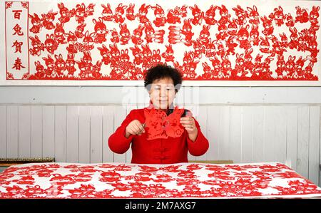 HANDAN, CHINA - JANUARY 9, 2023 - Folk paper-cutting artist Feng Shiping creates paper-cuts for the Year of Rabbit in Handan city, North China's Hebei Stock Photo