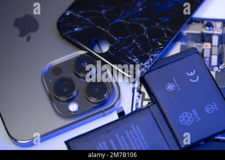 South Tyrol, Italy - Jan. 7. 2023: Broken iPhone display on top of new iPhone model. Replacement parts for Smartphone Stock Photo