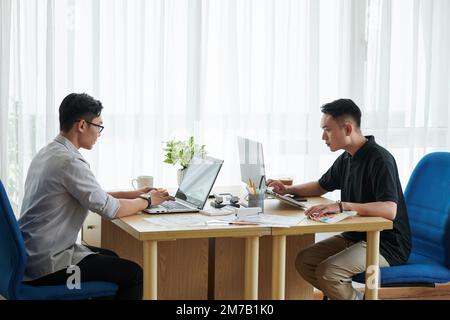 Team of young architects working in office on big project Stock Photo
