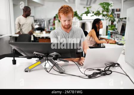 Smart technology makes everything easier. A young man working on a large touchscreen. Stock Photo