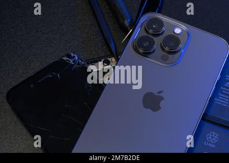 South Tyrol, Italy - Jan. 7. 2023: Apple iPhone 13 Pro on top of old iPhone and repair tools Stock Photo