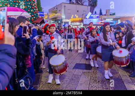 Nazareth, Israel - January 06, 2023: Orthodox Christmas Eve parade, with participants and crowd, in Nazareth, Israel Stock Photo
