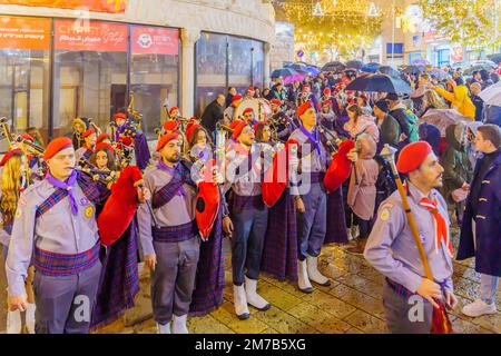Nazareth, Israel - January 06, 2023: Orthodox Christmas Eve parade, with participants and crowd, in Nazareth, Israel Stock Photo