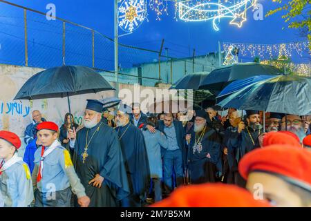 Nazareth, Israel - January 06, 2023: Orthodox Christmas Eve parade, with the patriarch, participants, and crowd, in Nazareth, Israel Stock Photo