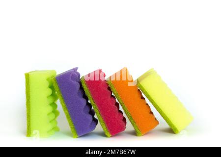 Stack of many multi-colored dish wash sponges isolated on white background. Household cleaning scrub pad. Home cleaning concept. Space for text Stock Photo