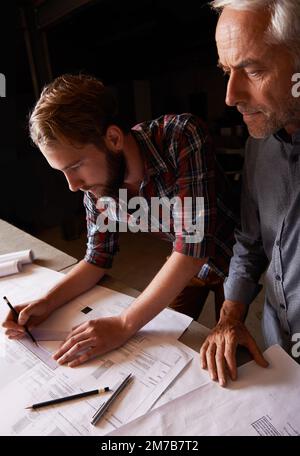 Turning his vision into reality. An architect drawing up plans. Stock Photo