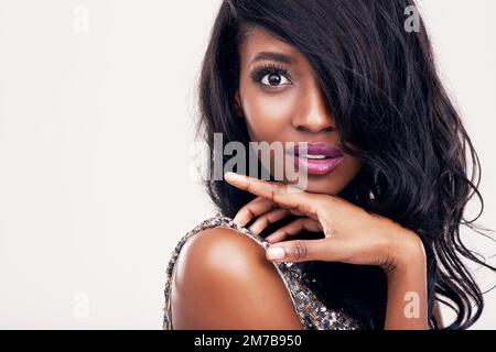 Eye-catching beauty. Portrait of a beautiful young woman posing in studio. Stock Photo