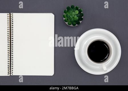 Blank notepad and coffee cup, conceptual minimalism. Stock Photo