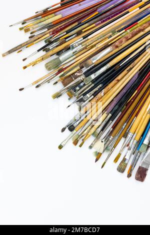 Many brushes for painting on a white background, top view. Stock Photo