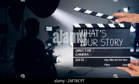 What's your story, Handwriting on film slate or clapperboard .film crew working in the studio. Stock Photo