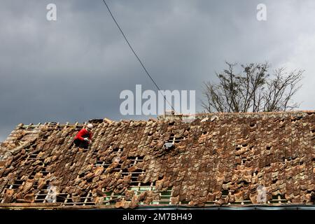 Cianjur, West Java, Indonesia. 9th Jan, 2023. A man is seen repair their roof of house in Gasol, Cianjur. (Credit Image: © Algi Febri Sugita/ZUMA Press Wire) Credit: ZUMA Press, Inc./Alamy Live News Stock Photo