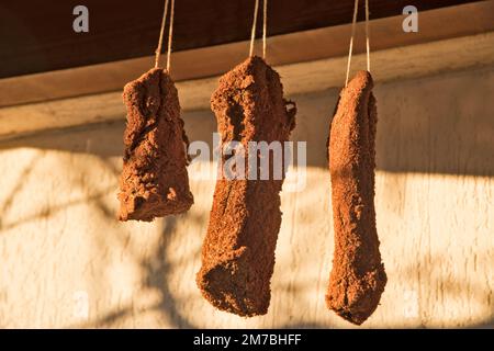 Homemade pastrami hanging to dry outdoor closeup Stock Photo