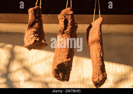 Homemade pastrami hanging to dry outdoor closeup Stock Photo