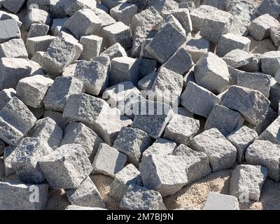 heap of cobblestones background, paving stone building material at construction site Stock Photo