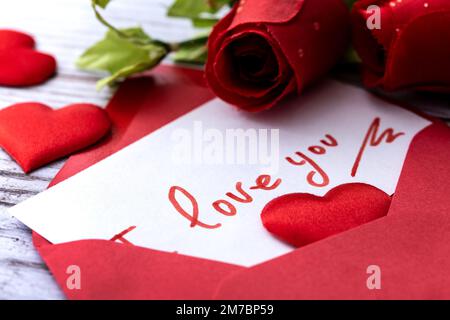 Set heart shaped boxes decorated with pink and red hearts on red background Stock Photo