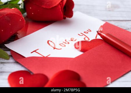 Set heart shaped boxes decorated with pink and red hearts on red background Stock Photo