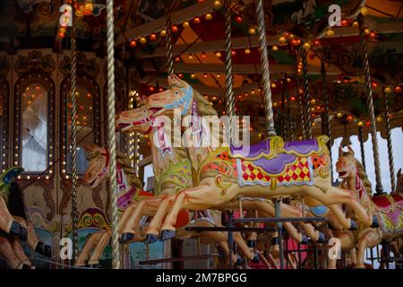 Empty horse-shaped seats on vintage merry-go-round ready to ride at the Seafront Fun Fair annual event in Bray, Co. Wicklow, Ireland. Stock Photo