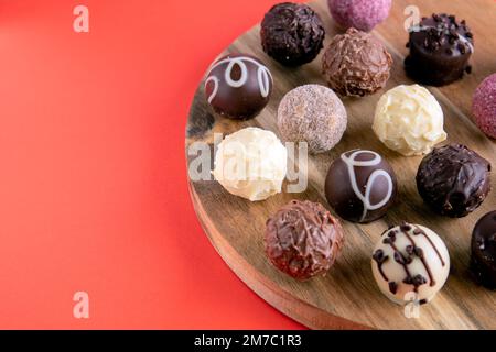 photo chocolates on a wooden board lying in a row Stock Photo