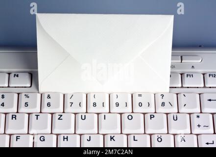 empty envelope on a white keyboard, snail-Mail versus e-mail Stock Photo