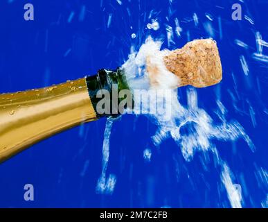 cork shooting out of a champagne bottle, popping the corks Stock Photo