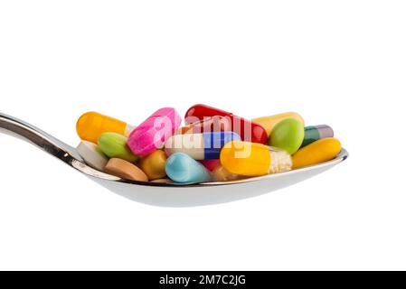 colourful pills on a spoon, cutout Stock Photo