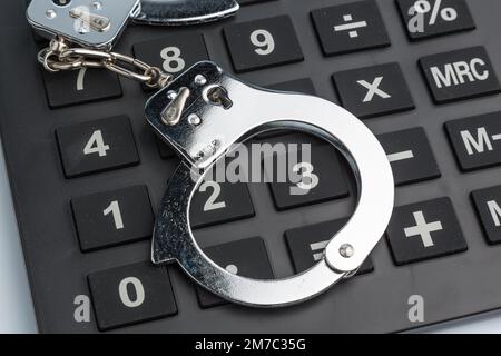 calculator with handcuff Stock Photo
