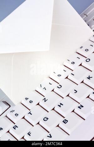 empty envelope on a white keyboard, snail-Mail versus e-mail Stock Photo