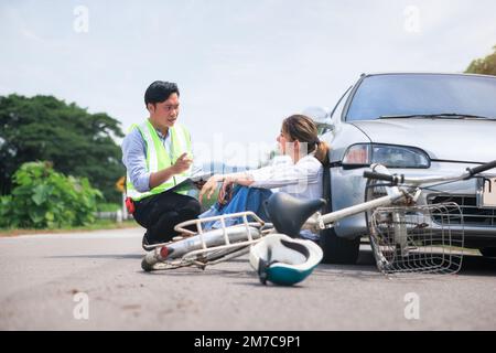 Accident, crash or collision of auto car, bicycle at outdoor. Include people i.e. insurance officer man and young girl or bicycle rider to injury on r Stock Photo