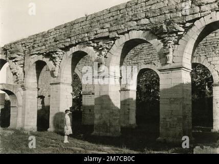 Woman standing in front of ancient Roman ruins, Rome, Italy 1920s Stock Photo