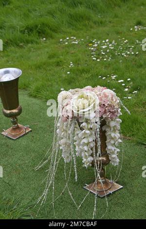 arrangement of artificial flowers on grave Stock Photo