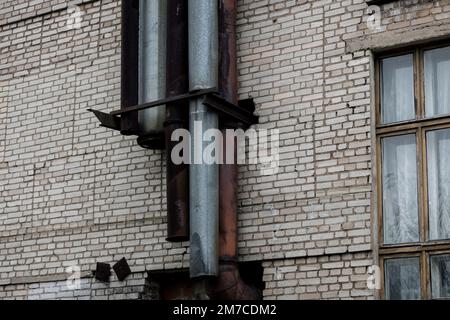 metal pipes on the wall of old brick building. industrial architecture Stock Photo