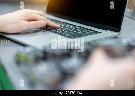 Close up of female hands typing on laptop keyboard Stock Photo