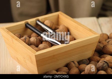 nutcracker in a wooden box with walnuts Stock Photo