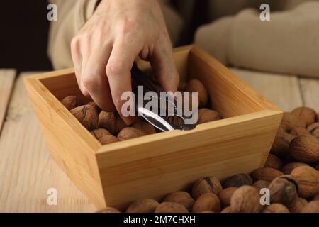 a person takes out a nutcracker from a wooden case standing on the table Stock Photo