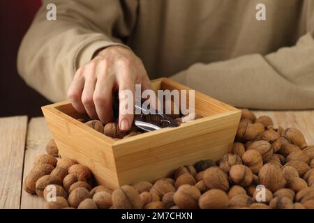 a person takes out a nutcracker from a wooden case standing on the table Stock Photo