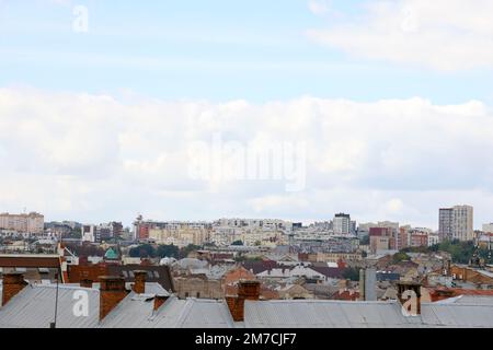 LVIV, UKRAINE - SEPTEMBER 11, 2022 Panorama view of the historical old city in Lviv, Ukraine. Many old buildings with metal roofs and cathedral domes in beginning of autumn day Stock Photo