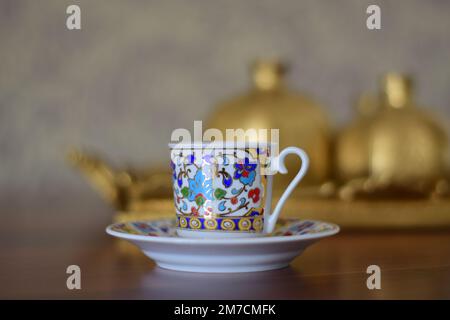 traditional coffee cup and gilded home accessories in the background Stock Photo