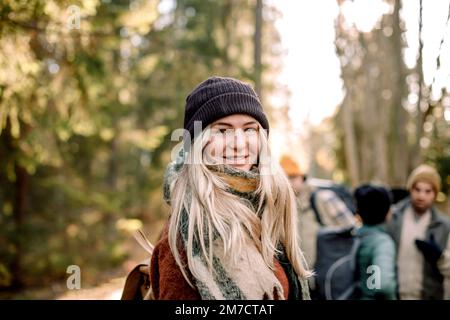 Side view of smiling young woman with blond hair Stock Photo