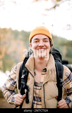 Portrait of happy young man wearing knit hat during hiking Stock Photo