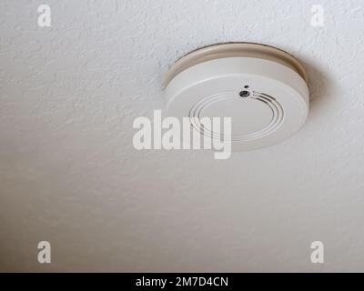 Residential home ceiling smoke detector fire alarm. Stock Photo